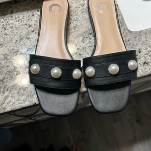 Woman’s black with pearls flat sandals